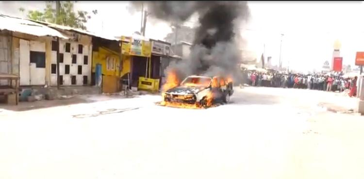 Brikama’s fire woes take new twist as car goes into flames in middle of road – But there is no social distancing as crowd forms at scene
