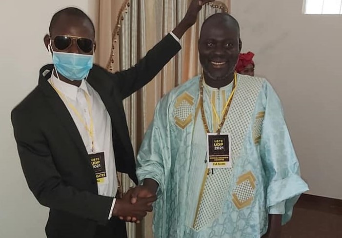 Hagi Suwaneh shakes hand of Three Years Jotna chief as he thanks UDP for the trust and confidence