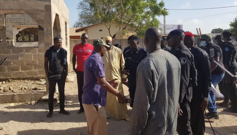 Abubakary Jawara, his brother and top police commander tour Sanyang police station ahead of his plan to restore the facility after it got set on fire